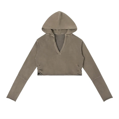 Vintage washed raw edge hoodie by ODMPOD, featuring a relaxed fit and distressed hem, displayed on a hanger.