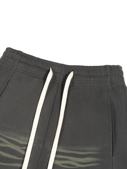 ODMPOD Sunfade Curved Blade fleece sweatpants showing the relaxed fit and curved hem in soft, comfortable fabric.
