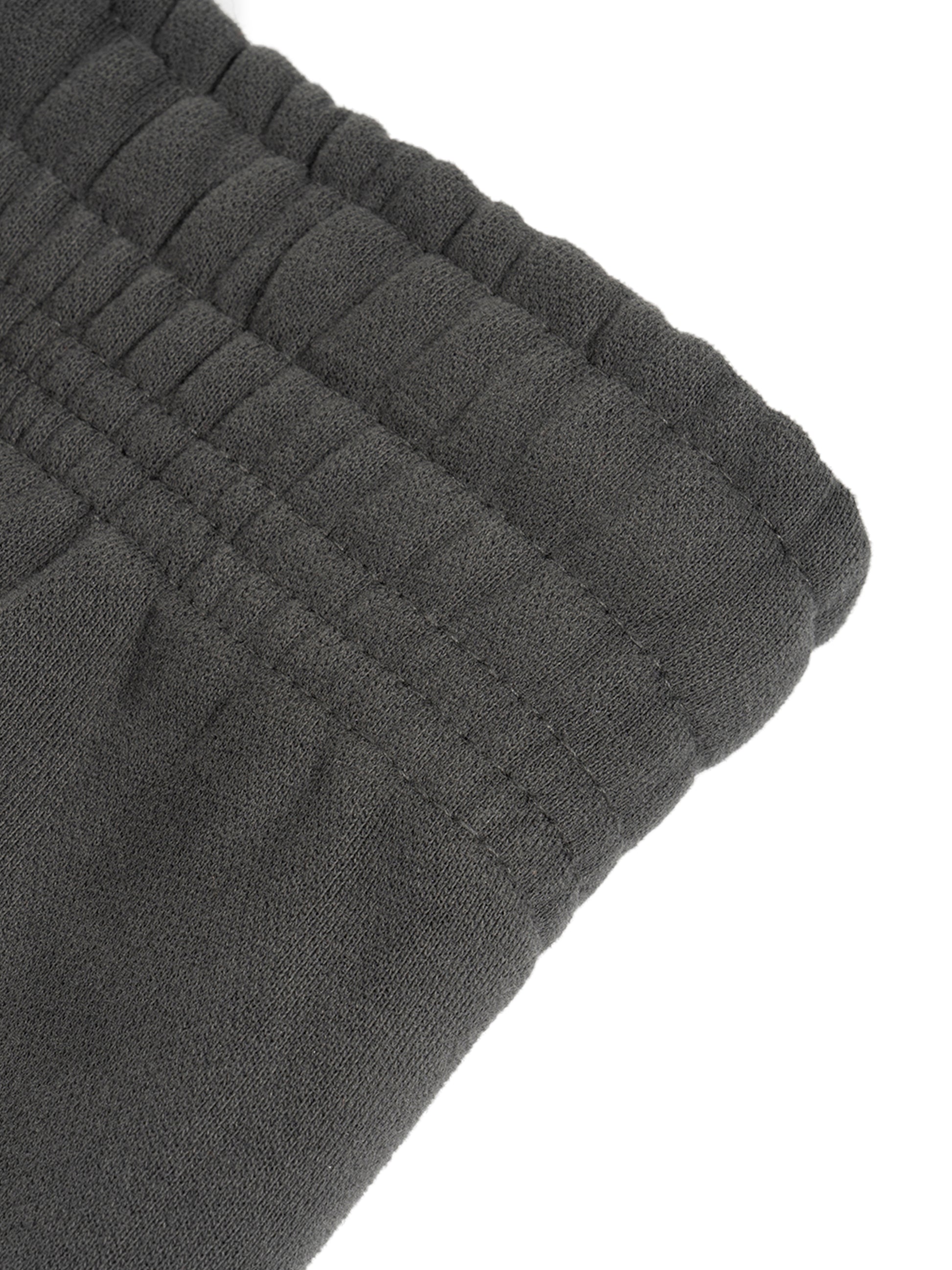 ODMPOD Sunfade Curved Blade fleece sweatpants showing a relaxed fit and curved hem in soft fleece fabric