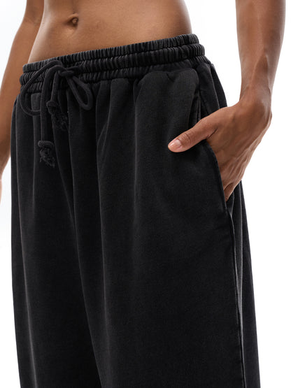 ODMPOD snow washed straight leg pants, light blue denim with a relaxed fit, displayed on a hanger against a neutral background.