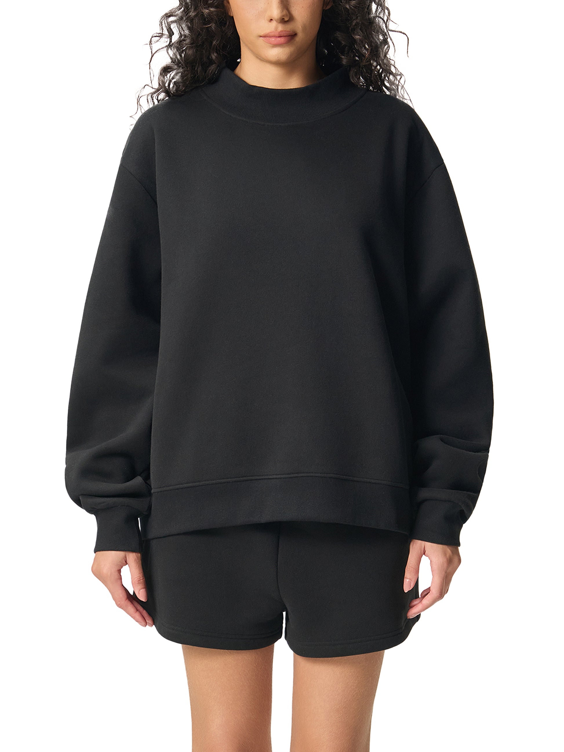 ODMPOD Essential fleece mock-neck crew sweatshirt in soft fabric, shown in a relaxed fit with long sleeves and ribbed cuffs.