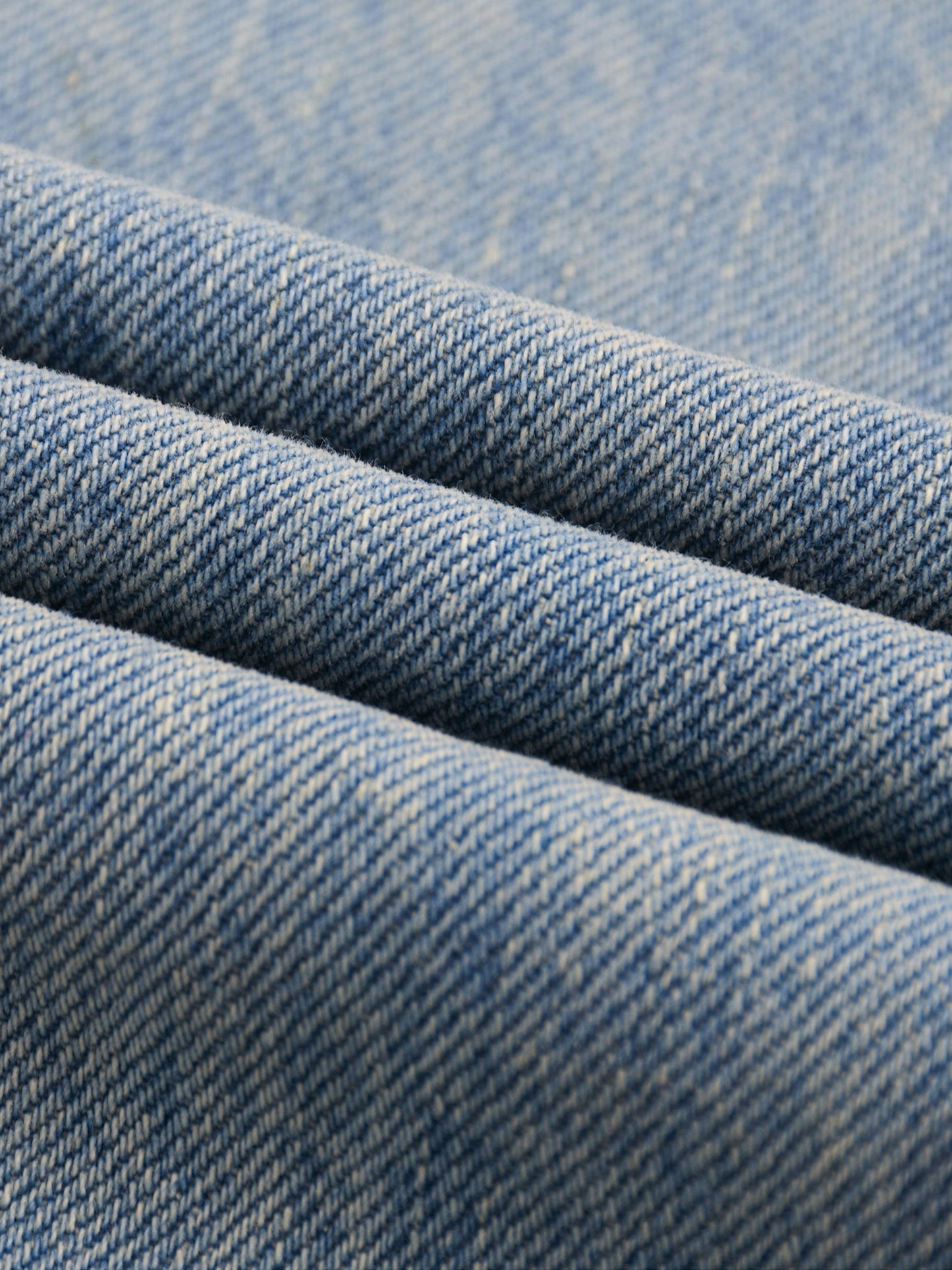 ODMPOD Sun Fade Raw Hem Denim Jeans showing distressed raw hem and faded sun-washed denim fabric.