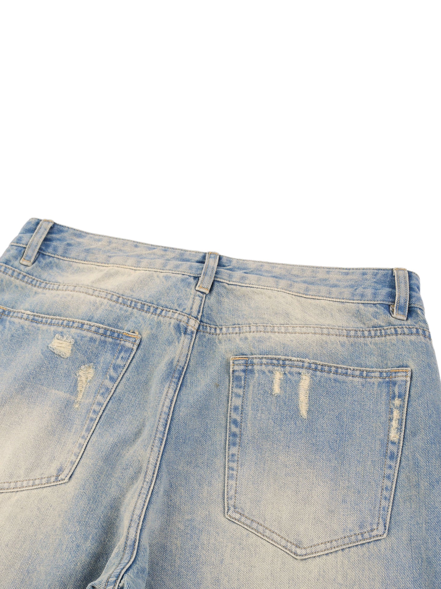 ODMPOD Sun Fade Raw Hem Denim Jeans, close-up of distressed light-wash denim with raw hem detail and faded sun-inspired design.