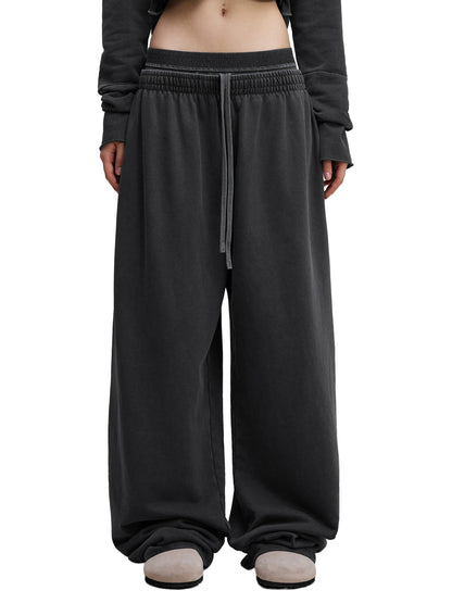 ODMPOD vintage washed waist pants with relaxed fit, featuring faded denim texture and classic waistline design.