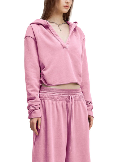 Vintage washed raw edge hoodie by ODMPOD, showing soft fabric, distressed hem, and relaxed fit on a hanger.